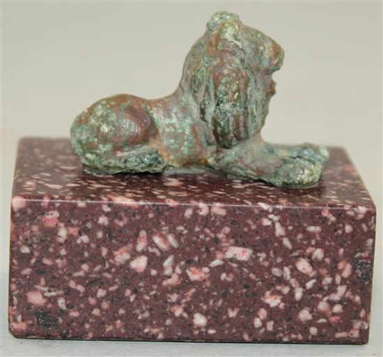 A small Roman bronze figure of a recumbent lion, c.2nd century AD, 5cm